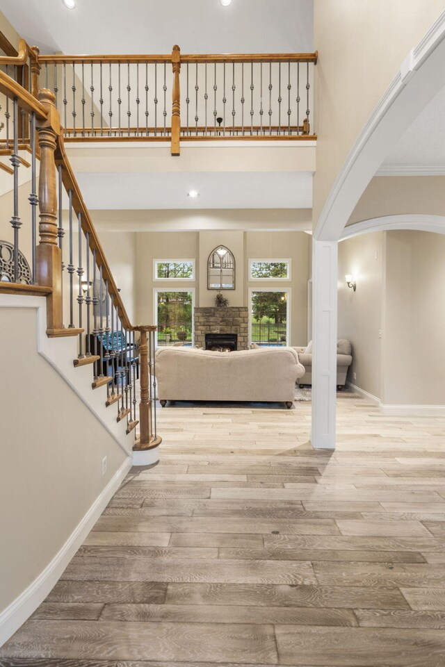 2421 Candlebark Ln, Lebanon, MO 65536 - entryway with wood finished floors, arched walkways, stairway, a towering ceiling, and recessed lighting