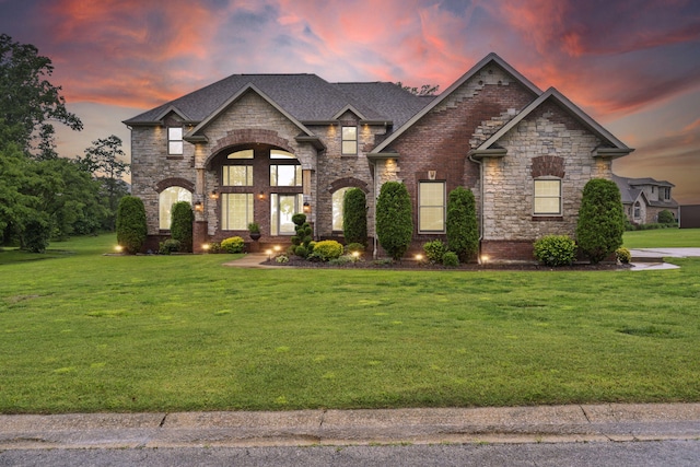 2421 Candlebark Ln, Lebanon, MO 65536 - french country style house with a yard, stone siding, brick siding, and a shingled roof