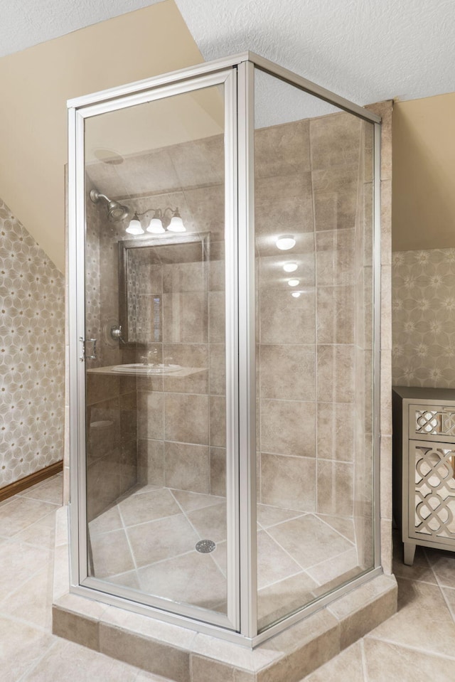2421 Candlebark Ln, Lebanon, MO 65536 - full bathroom featuring a shower stall, tile patterned flooring, and a textured ceiling