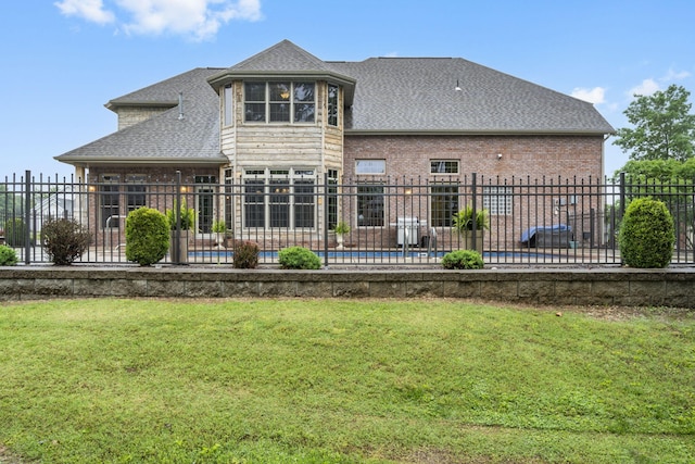 2421 Candlebark Ln, Lebanon, MO 65536 - rear view of house with a shingled roof, brick siding, and a patio