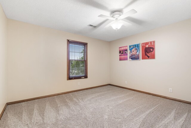 2421 Candlebark Ln, Lebanon, MO 65536 - carpeted spare room featuring a ceiling fan and a textured ceiling