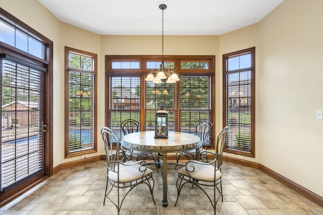 2421 Candlebark Ln, Lebanon, MO 65536 - dining space featuring stone tile flooring and a chandelier