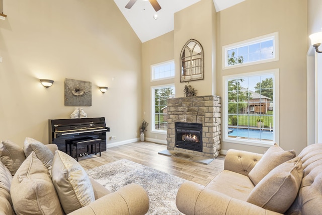 2421 Candlebark Ln, Lebanon, MO 65536 - living room featuring high vaulted ceiling, a ceiling fan, wood finished floors, and a fireplace