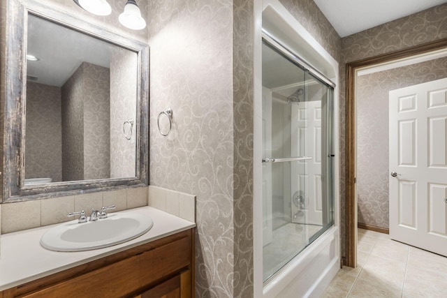 2421 Candlebark Ln, Lebanon, MO 65536 - bathroom with wallpapered walls, tile patterned flooring, enclosed tub / shower combo, and vanity