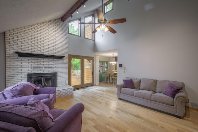 10703 Lawrence Unit 2230, Monett, MO 65708 - living room featuring a ceiling fan, wood finished floors, a brick fireplace, beam ceiling, and high vaulted ceiling