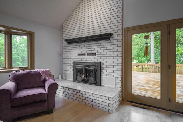 10703 Lawrence Unit 2230, Monett, MO 65708 - living room with lofted ceiling, wood finished floors, and a brick fireplace