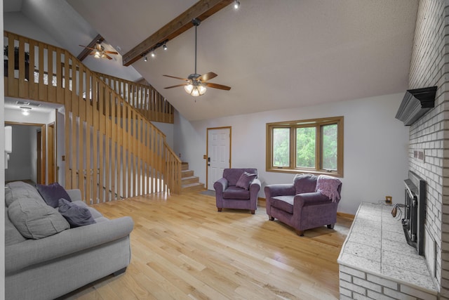 10703 Lawrence Unit 2230, Monett, MO 65708 - living room featuring a ceiling fan, rail lighting, light wood-style flooring, stairs, and high vaulted ceiling