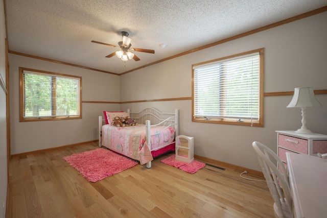 10703 Lawrence Unit 2230, Monett, MO 65708 - bedroom with multiple windows, light wood-style floors, a textured ceiling, crown molding, and baseboards
