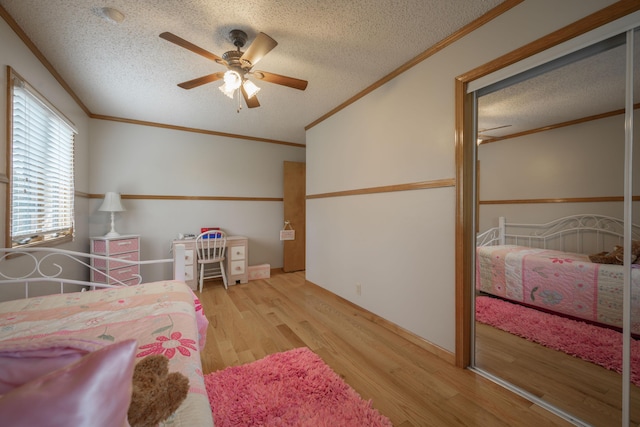 10703 Lawrence Unit 2230, Monett, MO 65708 - bedroom featuring a textured ceiling, wood finished floors, ornamental molding, and a ceiling fan