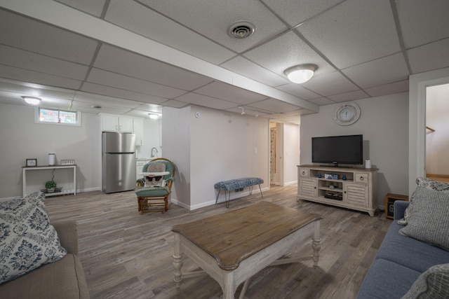 10703 Lawrence Unit 2230, Monett, MO 65708 - living area with light wood-style flooring, a drop ceiling, and baseboards