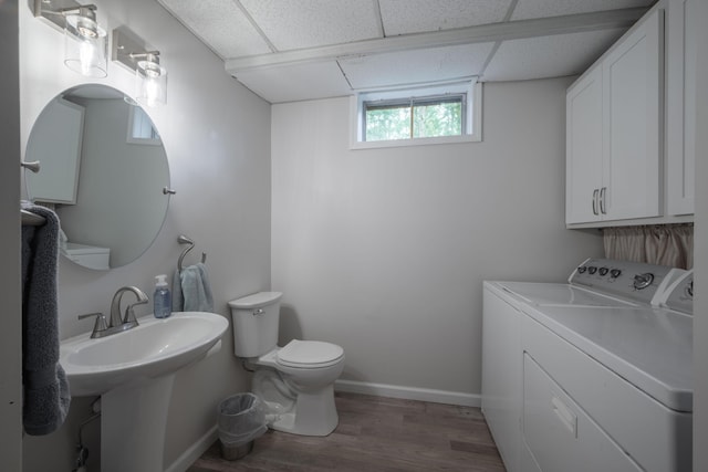 10703 Lawrence Unit 2230, Monett, MO 65708 - bathroom with washing machine and dryer, wood finished floors, toilet, a drop ceiling, and baseboards