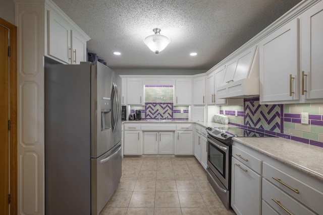 10703 Lawrence Unit 2230, Monett, MO 65708 - kitchen featuring stainless steel appliances, tasteful backsplash, light countertops, a textured ceiling, and light tile patterned flooring