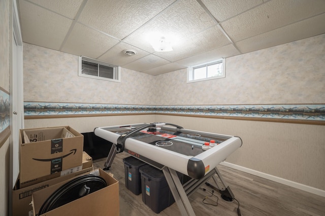 10703 Lawrence Unit 2230, Monett, MO 65708 - recreation room featuring wallpapered walls, a drop ceiling, a wainscoted wall, baseboards, and wood finished floors