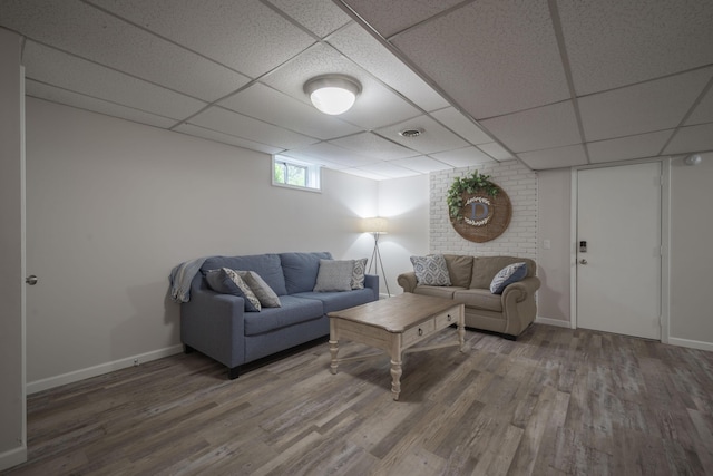 10703 Lawrence Unit 2230, Monett, MO 65708 - living area featuring a drop ceiling, wood finished floors, and baseboards