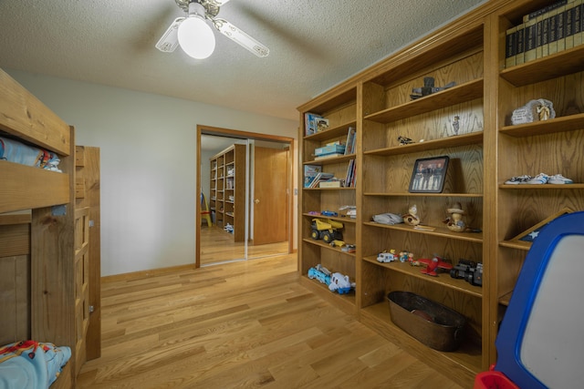 10703 Lawrence Unit 2230, Monett, MO 65708 - home office featuring light wood-style floors, ceiling fan, and a textured ceiling