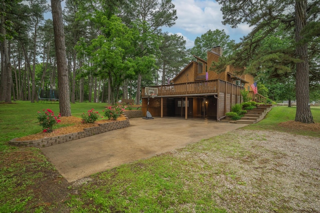 10703 Lawrence Unit 2230, Monett, MO 65708 - view of property exterior with a trampoline, a chimney, a yard, stairway, and a wooden deck