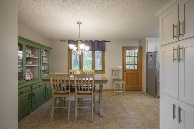 10703 Lawrence Unit 2230, Monett, MO 65708 - dining space featuring a chandelier, a textured ceiling, and light tile patterned floors