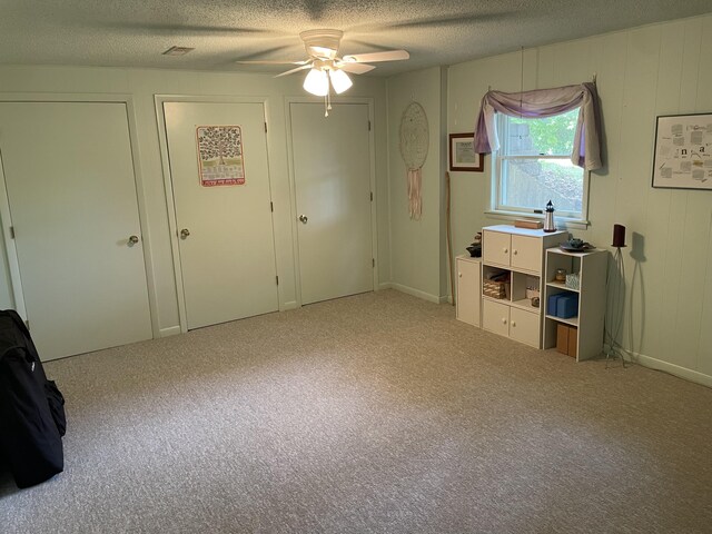2704 Jennifer Dr, West Plains, MO 65775 - unfurnished bedroom featuring a textured ceiling, carpet, multiple closets, and a ceiling fan