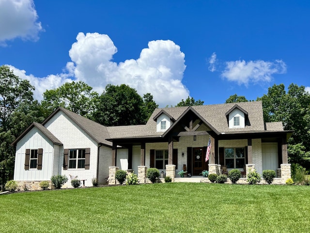 722 Seven Pines Dr, Saddlebrooke, MO 65630 - view of front of property with a porch, a front yard, board and batten siding, and brick siding