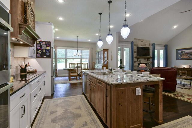 722 Seven Pines Dr, Saddlebrooke, MO 65630 - kitchen featuring a sink, stainless steel appliances, a breakfast bar area, light stone countertops, and recessed lighting