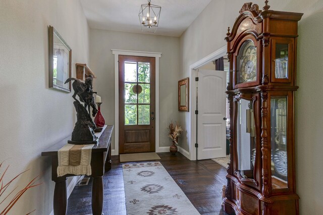 722 Seven Pines Dr, Saddlebrooke, MO 65630 - entrance foyer featuring dark wood finished floors, a chandelier, and baseboards