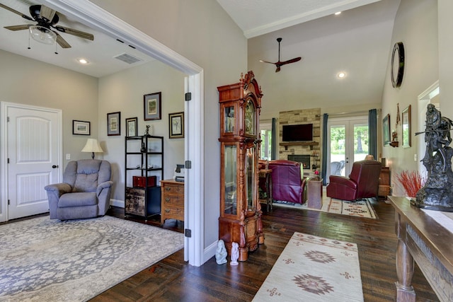 722 Seven Pines Dr, Saddlebrooke, MO 65630 - living room with a high ceiling, a ceiling fan, baseboards, a fireplace, and wood finished floors