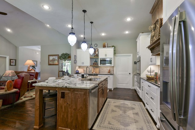 722 Seven Pines Dr, Saddlebrooke, MO 65630 - kitchen featuring stainless steel appliances, a sink, open floor plan, dark wood finished floors, and decorative backsplash