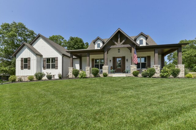 722 Seven Pines Dr, Saddlebrooke, MO 65630 - craftsman-style home with brick siding, a front yard, a porch, and board and batten siding