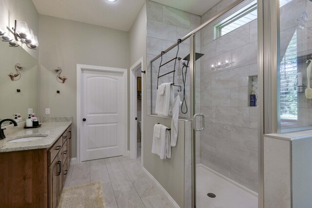 722 Seven Pines Dr, Saddlebrooke, MO 65630 - full bathroom featuring vanity, a shower stall, baseboards, and tile patterned floors