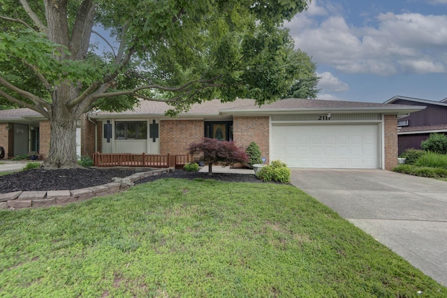 2117 E Wornall Pl, Springfield, MO 65804 - single story home featuring a garage, brick siding, concrete driveway, a front yard, and roof with shingles