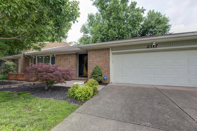 2117 E Wornall Pl, Springfield, MO 65804 - ranch-style house featuring concrete driveway, brick siding, and a garage