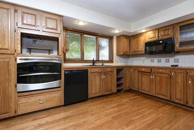 2117 E Wornall Pl, Springfield, MO 65804 - kitchen with black appliances, light wood-type flooring, brown cabinetry, and open shelves