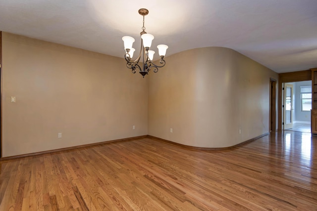 2117 E Wornall Pl, Springfield, MO 65804 - empty room featuring a chandelier and light wood-type flooring