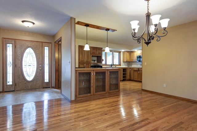 2117 E Wornall Pl, Springfield, MO 65804 - entrance foyer with a chandelier and light wood-style flooring