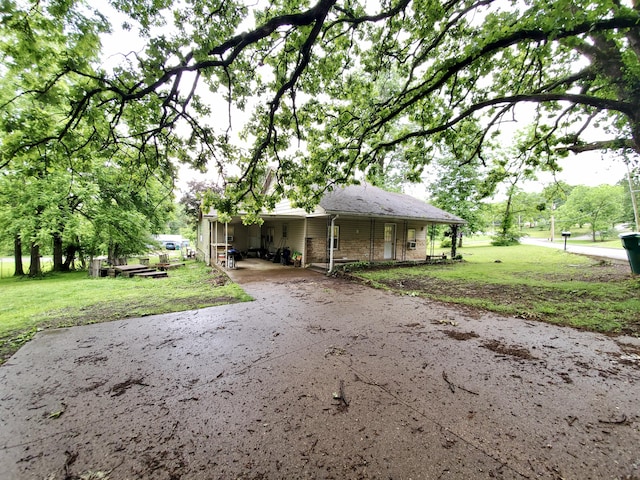 1010 Pine St, Cabool, MO 65689 - view of front of property with asphalt driveway, a front yard, brick siding, and a carport