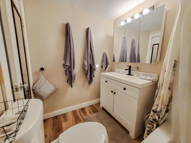1010 Pine St, Cabool, MO 65689 - full bathroom featuring vanity, wood finished floors, baseboards, and a bathtub