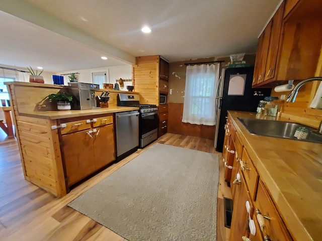 1010 Pine St, Cabool, MO 65689 - kitchen with stainless steel appliances, a sink, light wood finished floors, brown cabinets, and recessed lighting