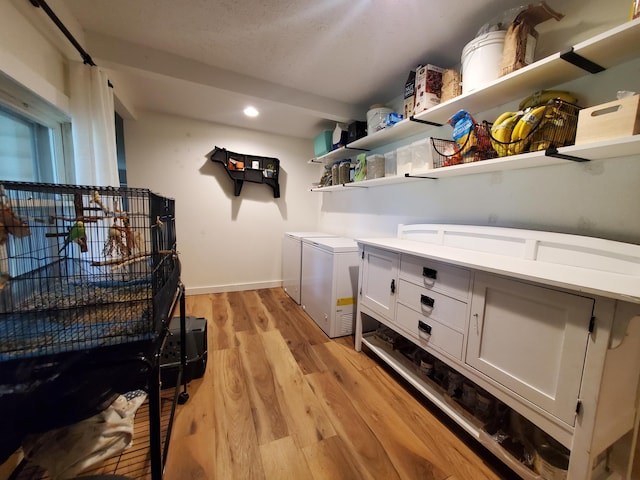1010 Pine St, Cabool, MO 65689 - laundry area with light wood finished floors, recessed lighting, baseboards, and washing machine and clothes dryer