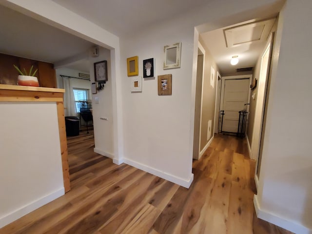 1010 Pine St, Cabool, MO 65689 - hallway featuring wood finished floors, attic access, and baseboards