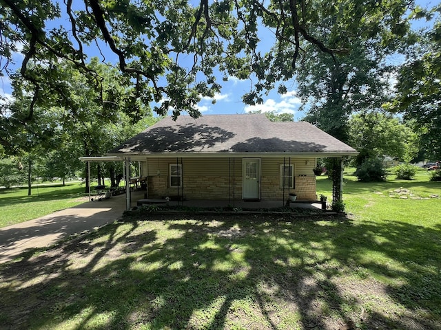 1010 Pine St, Cabool, MO 65689 - view of front of home featuring a front lawn, a carport, roof with shingles, and stone siding