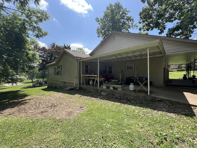 1010 Pine St, Cabool, MO 65689 - back of property with a lawn and an attached carport