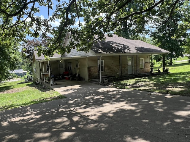 1010 Pine St, Cabool, MO 65689 - view of property exterior featuring driveway, a lawn, a carport, and stone siding