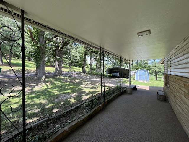 1010 Pine St, Cabool, MO 65689 - view of patio / terrace with a storage shed and a carport
