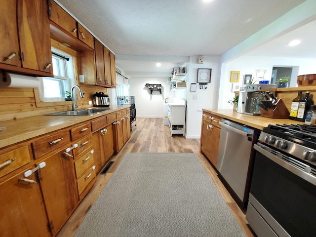 1010 Pine St, Cabool, MO 65689 - kitchen featuring stainless steel appliances, brown cabinetry, light wood-style floors, recessed lighting, and butcher block countertops