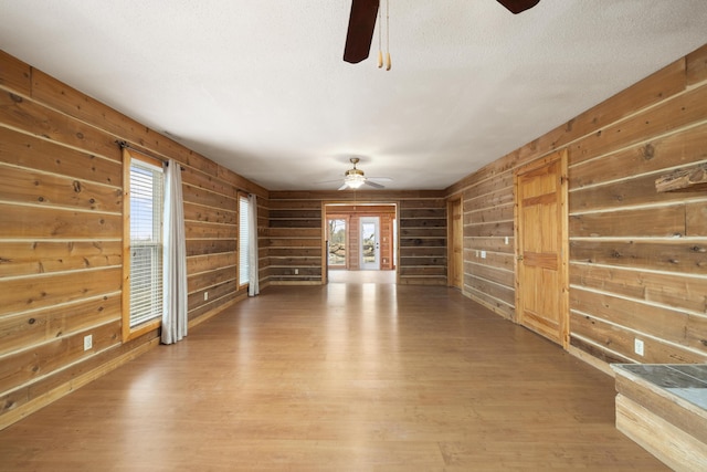 247 S Jefferson St, Walnut Grove, MO 65770 - unfurnished living room with ceiling fan, wooden walls, and light wood-style flooring