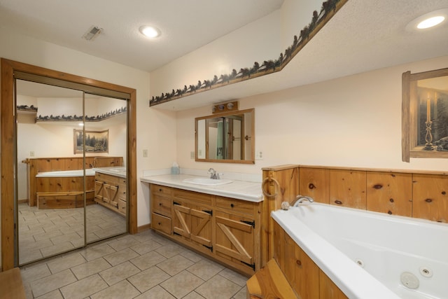 247 S Jefferson St, Walnut Grove, MO 65770 - full bath with vanity, a jetted tub, tile patterned flooring, and recessed lighting