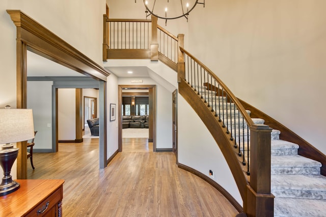 3596 E Montrose Ct, Springfield, MO 65809 - staircase with wood finished floors, baseboards, a chandelier, and a towering ceiling