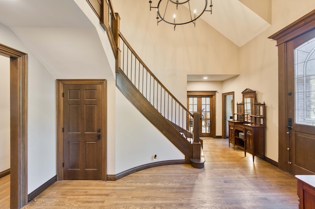3596 E Montrose Ct, Springfield, MO 65809 - entrance foyer featuring wood finished floors, a chandelier, stairs, baseboards, and high vaulted ceiling