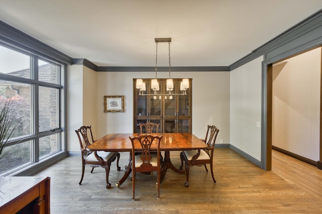 3596 E Montrose Ct, Springfield, MO 65809 - dining room with crown molding, plenty of natural light, light wood-type flooring, and baseboards