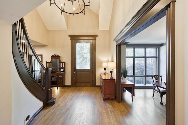 3596 E Montrose Ct, Springfield, MO 65809 - entrance foyer featuring wood finished floors, plenty of natural light, a chandelier, and high vaulted ceiling